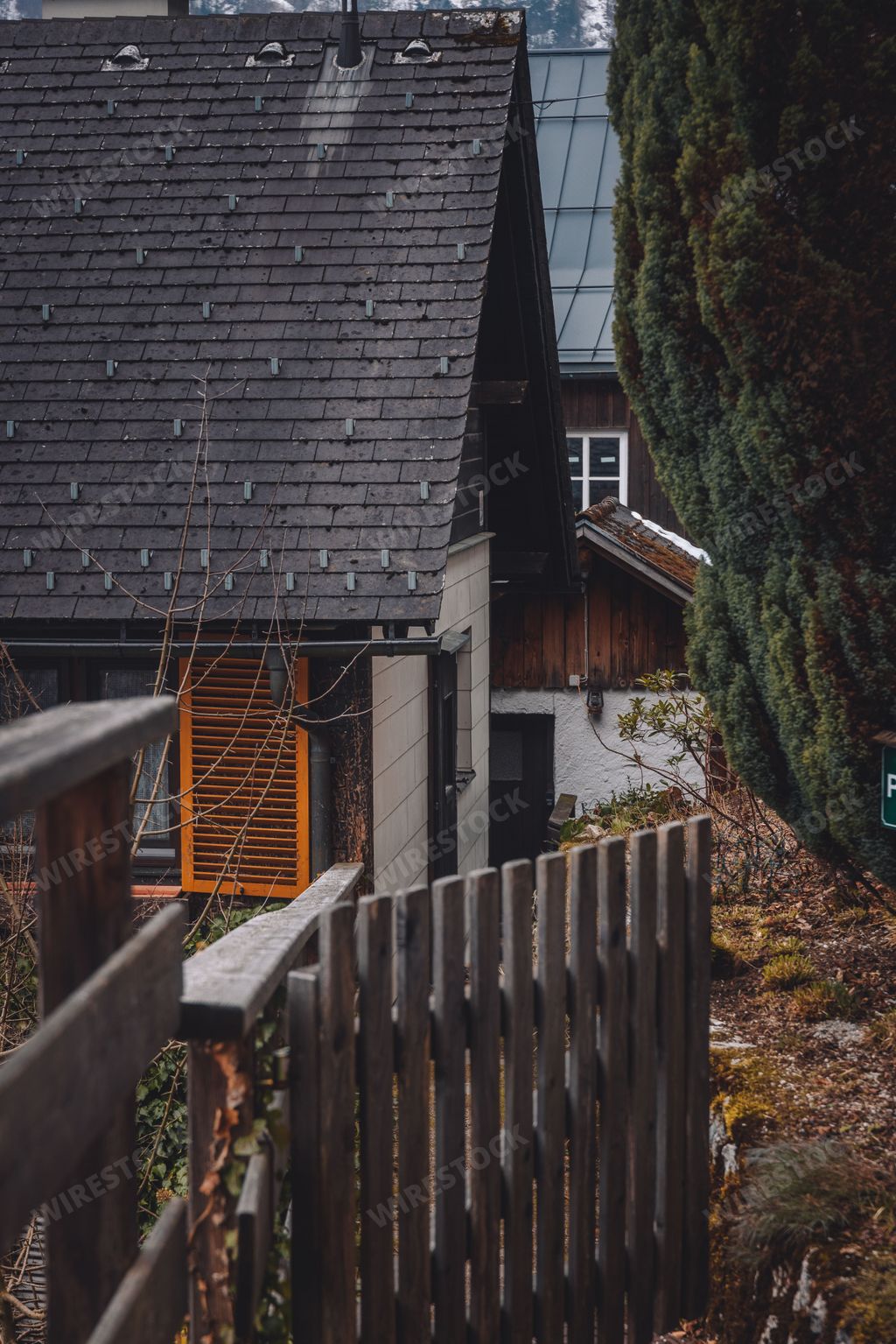 Wooden traditional chalets roofs in Hallstatt street in Austria with Austria alps on the horizon