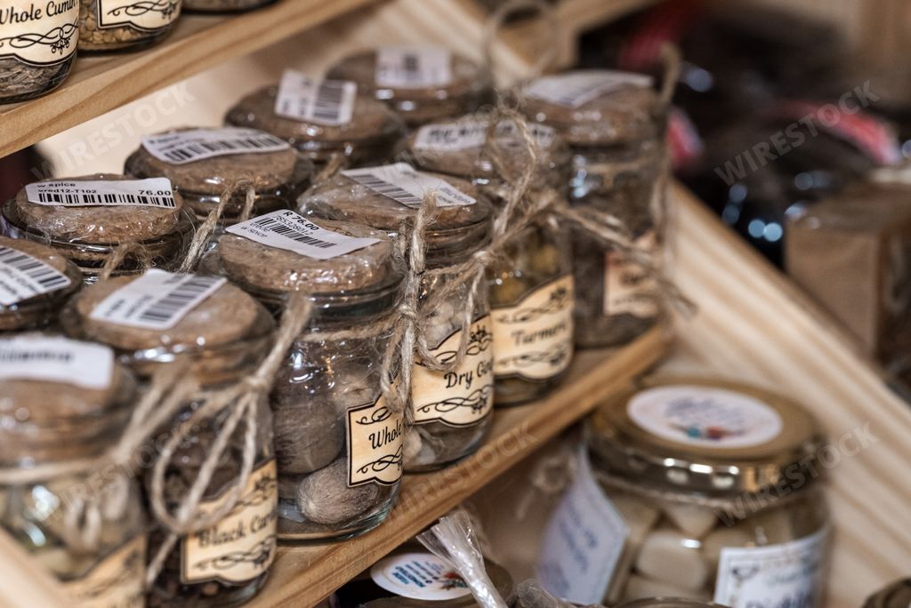 A closeup of pots of pickled food at a market stall