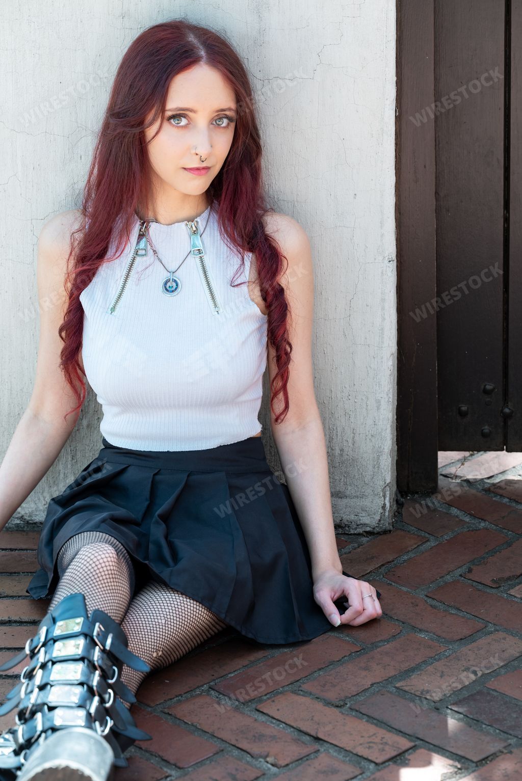 An attractive Alternative female model in an urban setting