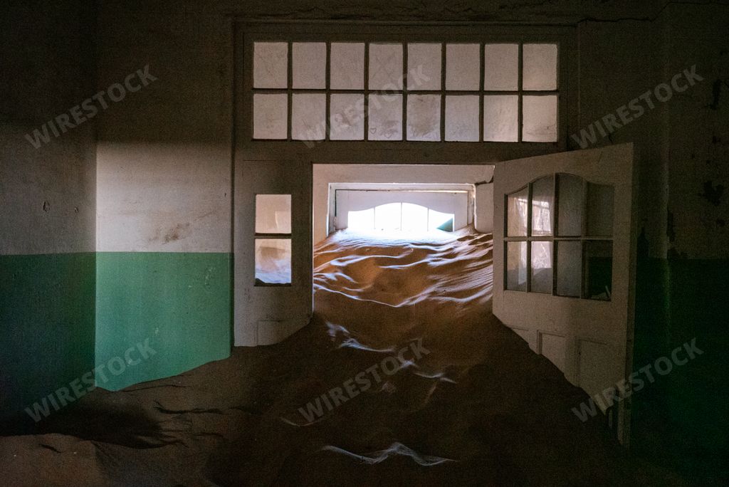 The Sand covering the floor of an abandoned hallway in an old desert town