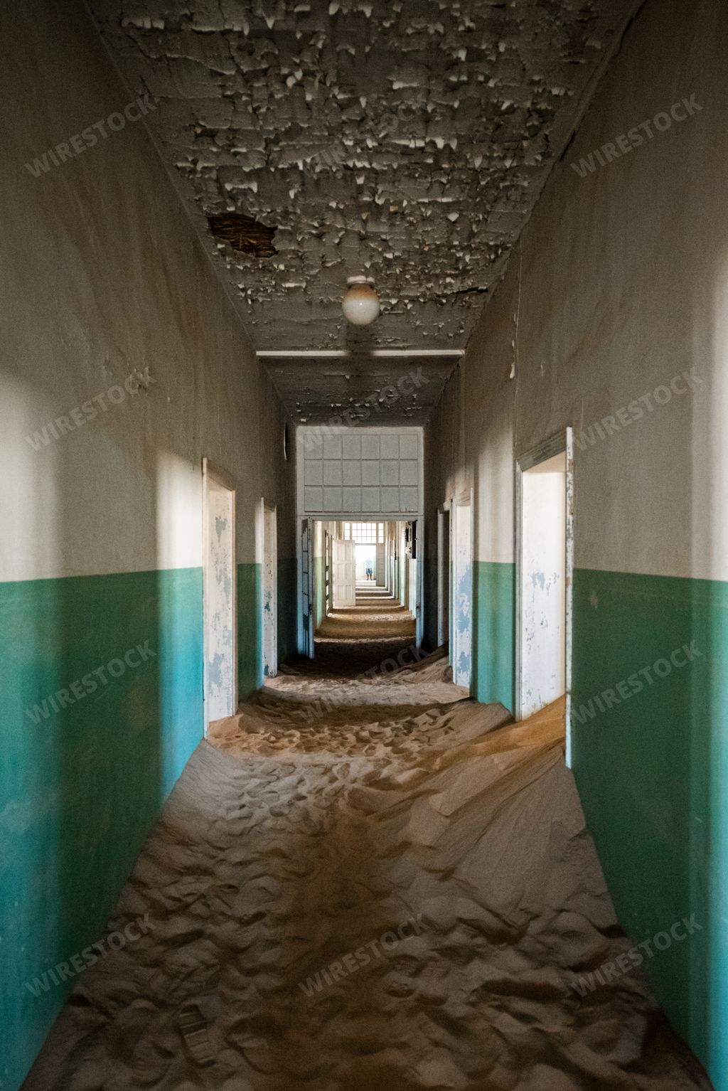 The Sand covering the floor of an abandoned hallway in an old desert town