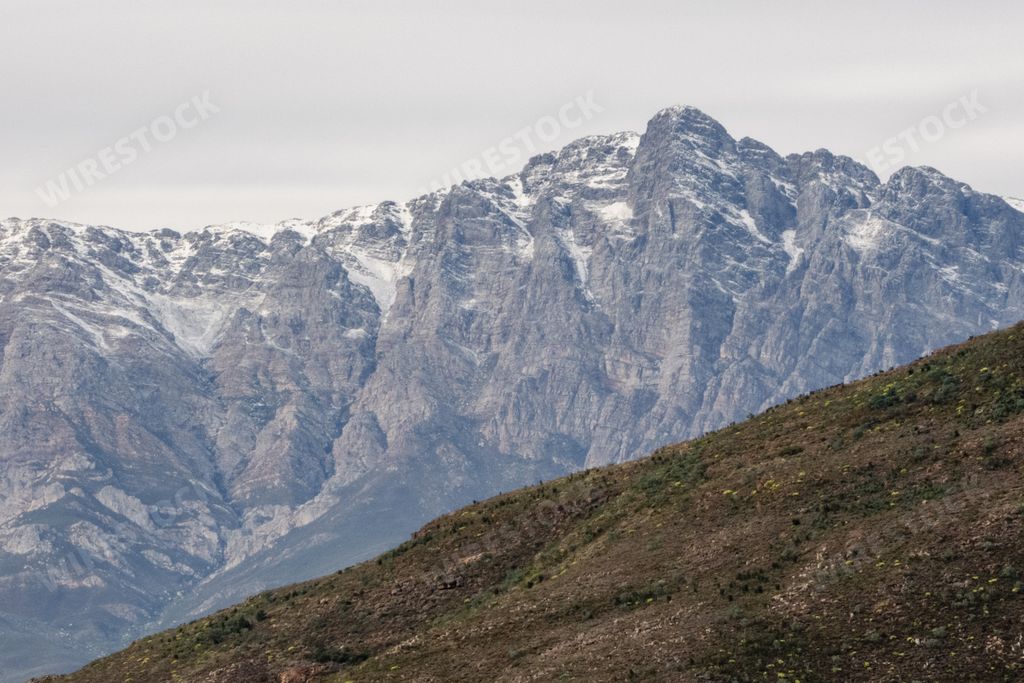 The snow-capped peaks of Breede Valley's distant mountains on a chilly day in Worcester, South Africa