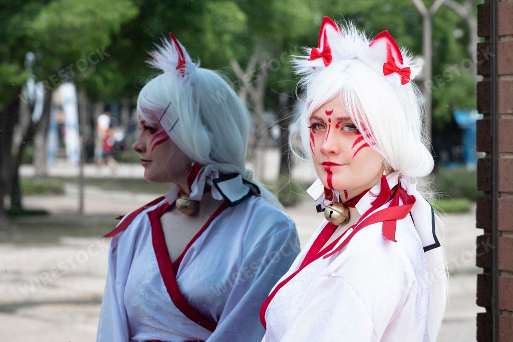 Female cosplayer in feline priestess attire at a convention