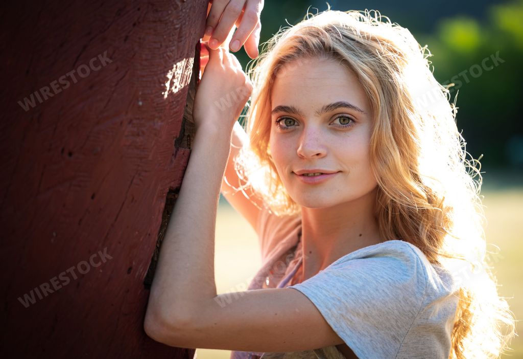 A blonde girl wearing a white dress photographed in a park in Stellenbosch, South Africa
