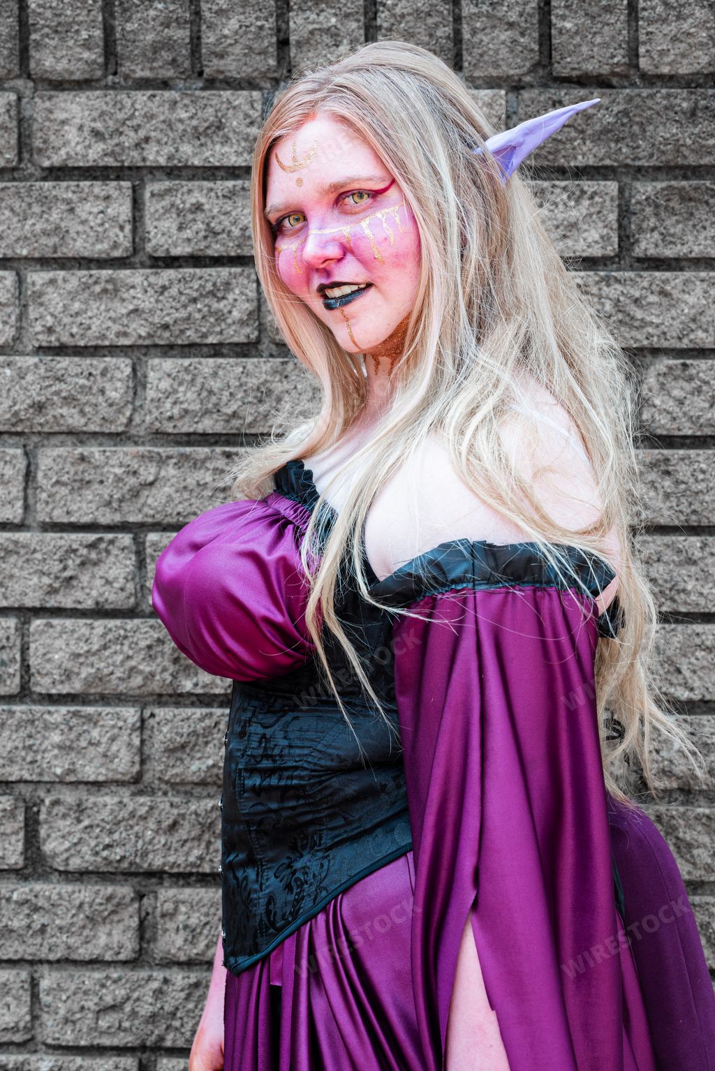 A female cosplayer in a fantasy witch costume