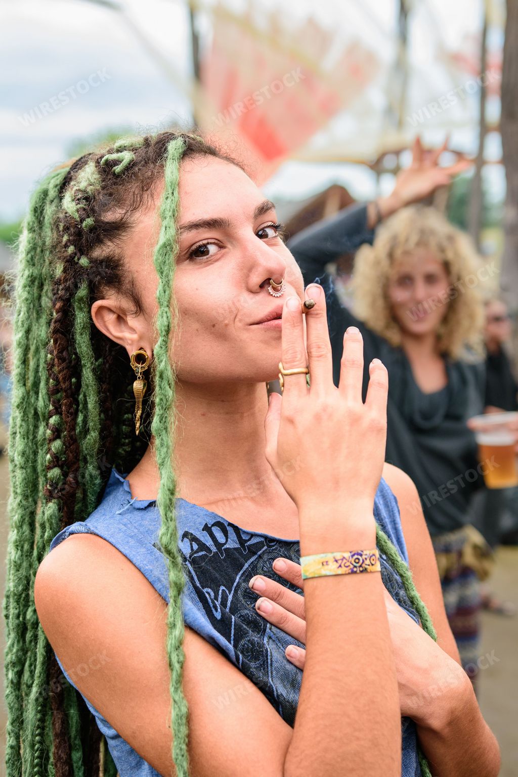 A young female with dreadlocks and facial piercings posing for the camera during the Ozora Festival