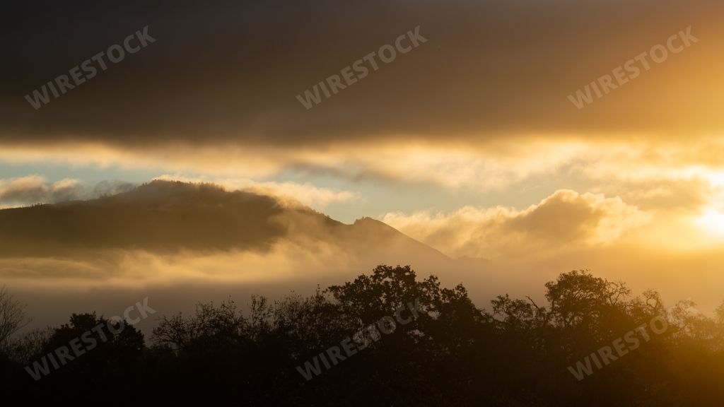 A beautiful sunset cloudy sky over mountains at Spring Lake in Santa Rosa California