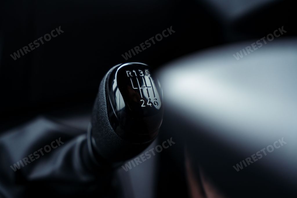 A car manual gear stick situated inside a vehicle dashboard