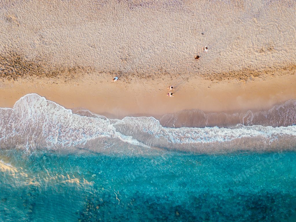 An aerial view of the sandy coast of the turquoise sea