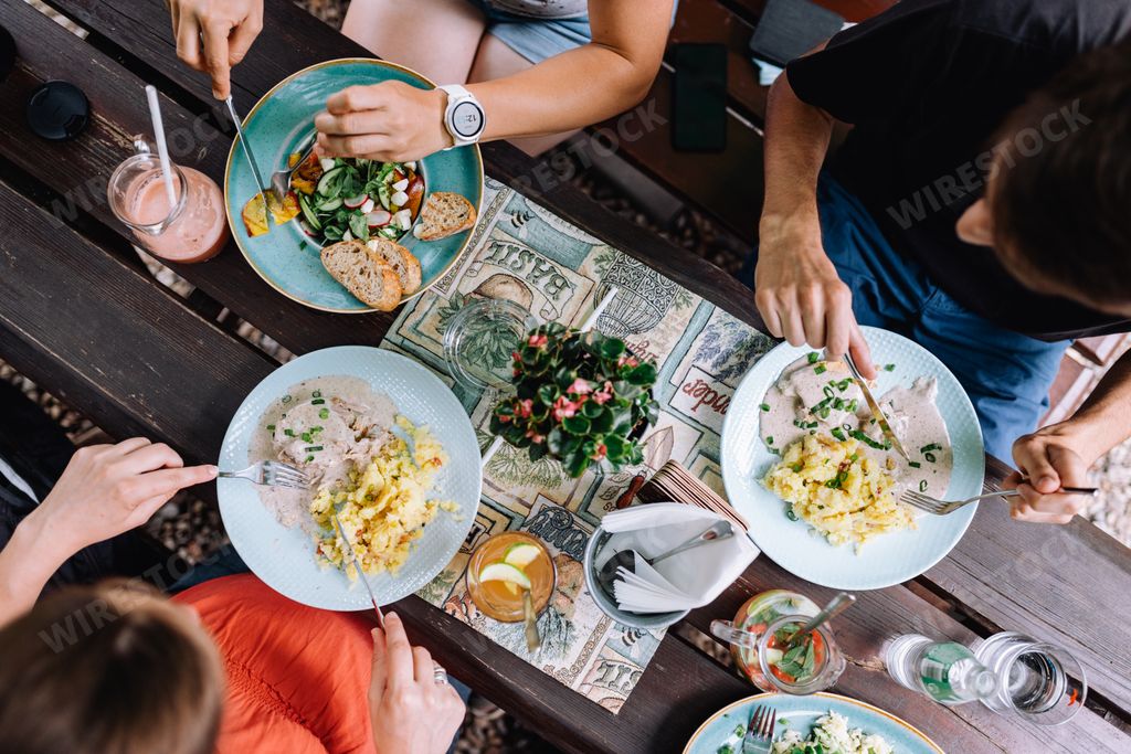 A closeup shot of friends having a lunch together in a restaurant