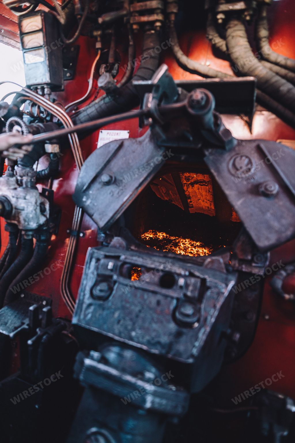 A closeup shot into the furnace inside the cabin of steam engine locomotive 475.196