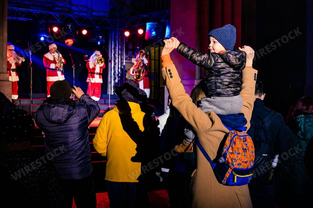 A kid sitting on his mother's shoulders, enjoying the concert at National Opera in Bucharest, Romania
