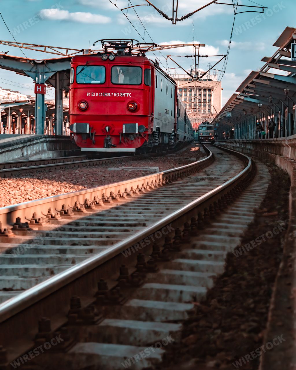 A vertical shot of a red train in North Railway station (Gara de Nord), Bucharest