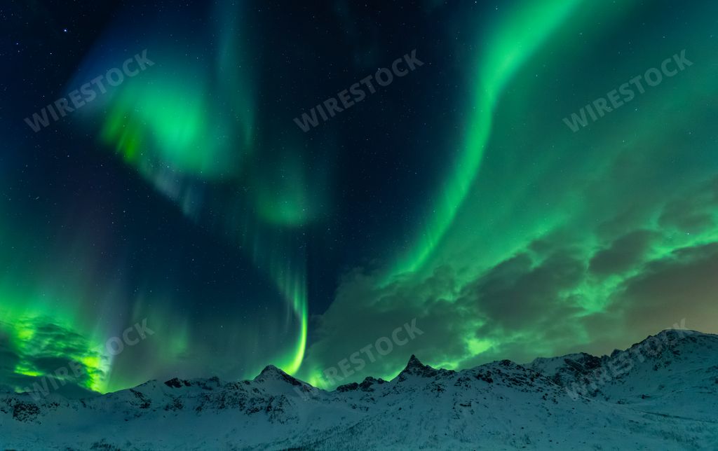A beautiful shot of the Northern lights over the sea near Tromso, Norway