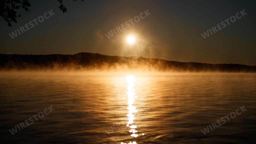 A scenic view of the Morning sunrise mist on Cedar Lake Algonquin Park in Canada