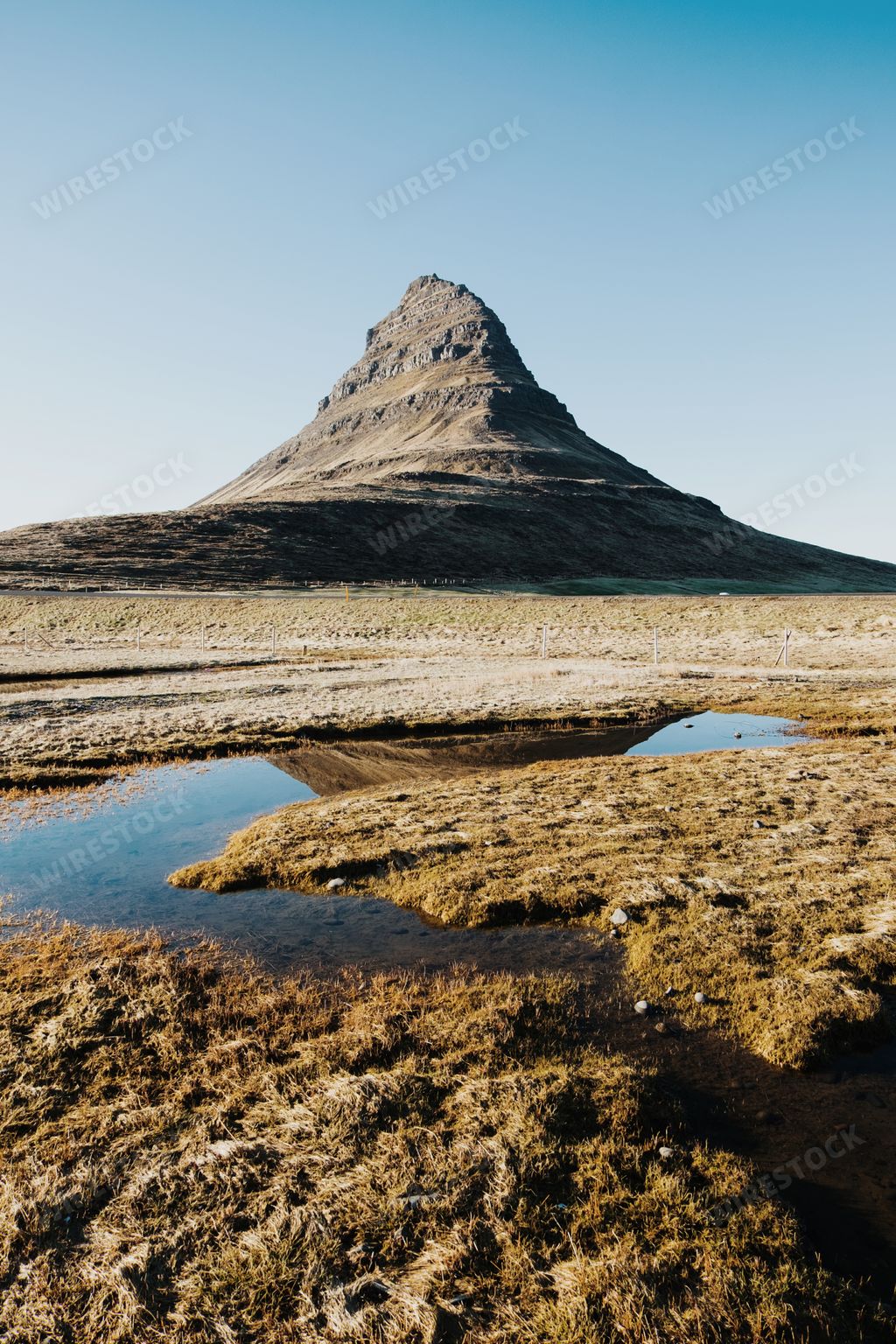 A vertical shot of the famous Kirkjufell Mountain in the Grundarfjordur town in Iceland