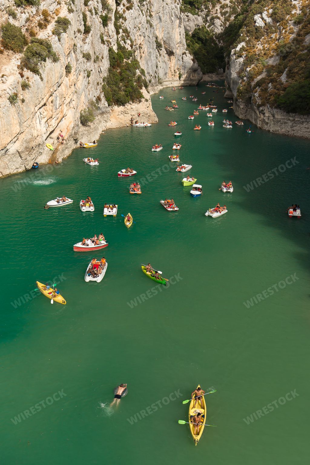 The Verdon Natural Regional Park with the boats on the water under the sunlight in France