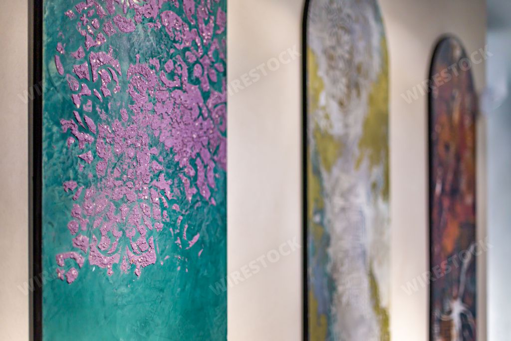 A selective focus shot of abstract arch paintings on a wall