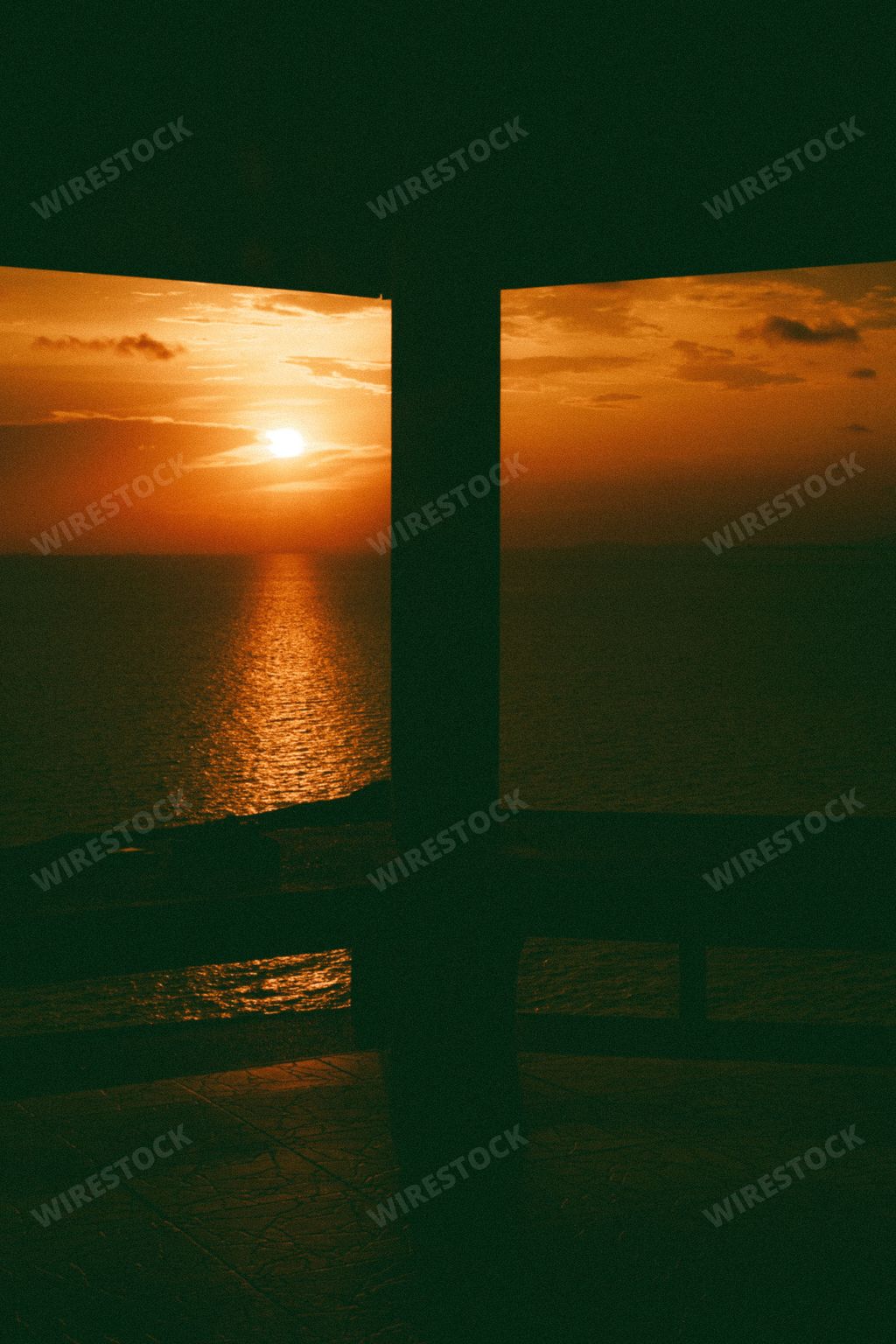 A vertical shot from a gazebo to the seascape in the sunset.