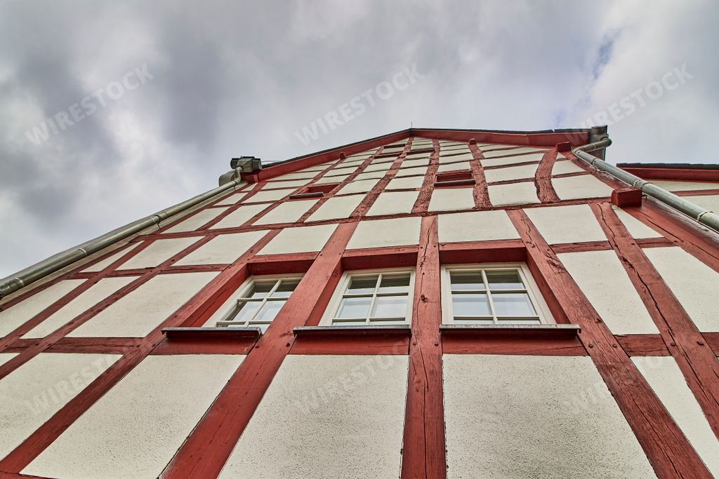 A low angle shot of a traditional building in the old village Monreal buildings, Germany with a blue cloudy sky