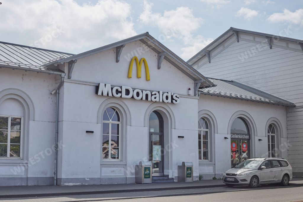 An entrance of a McDonald's restaurant white building