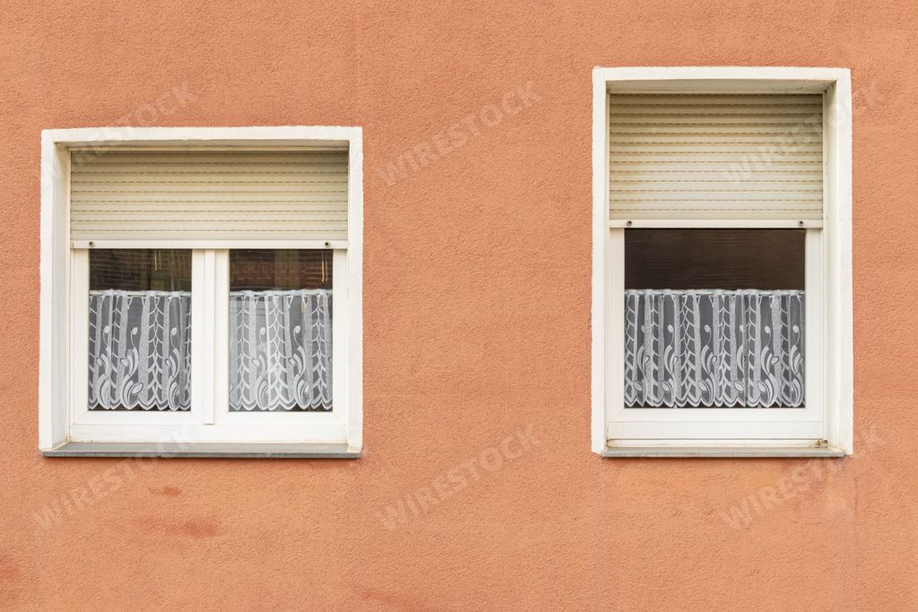 A beautiful view of windows on the facade of an orange building