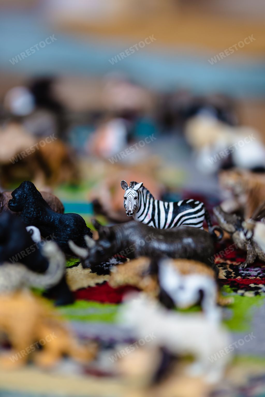 A selective focus shot of a zebra toy figurine on the carpet