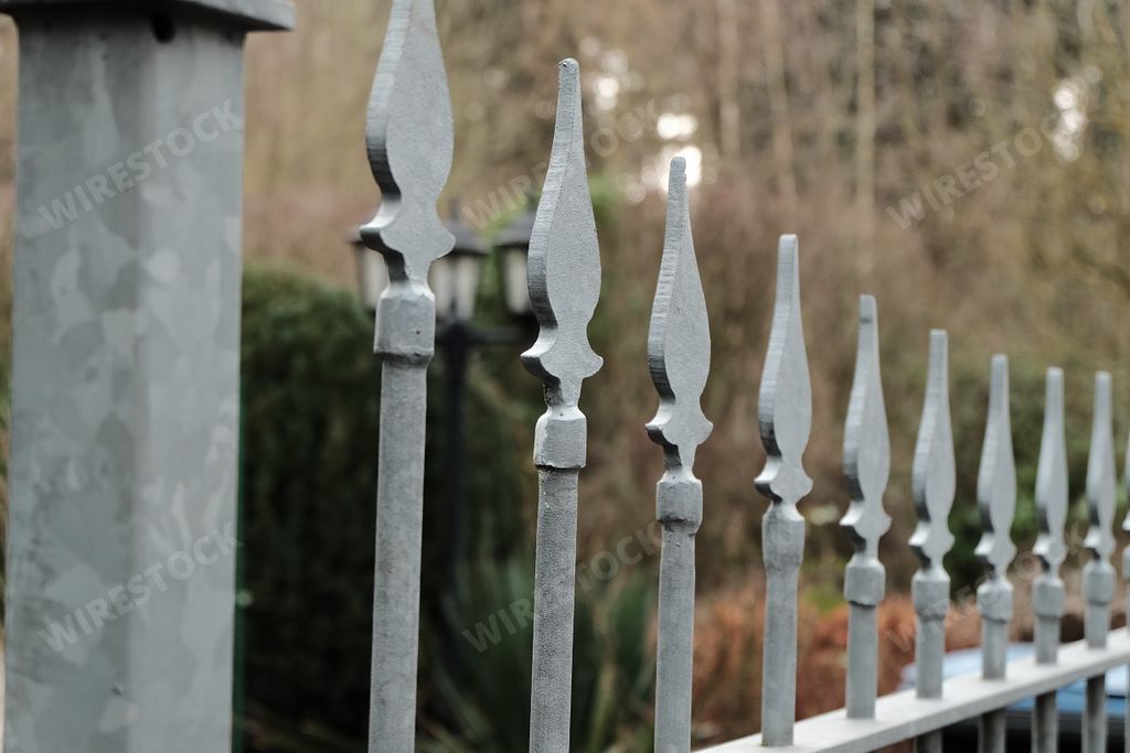 A closeup shot of a metal  fence with the blurred background