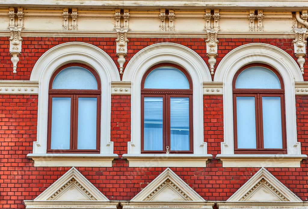 A red brick building facade with arched windows