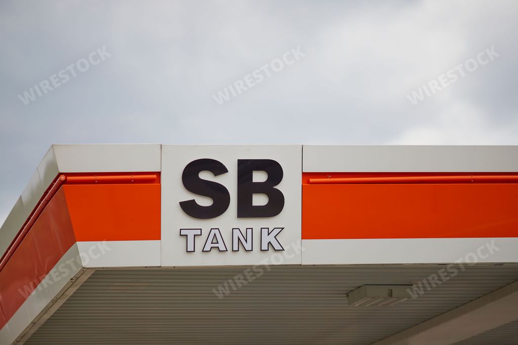 A gas station with SB TANK logo in the city