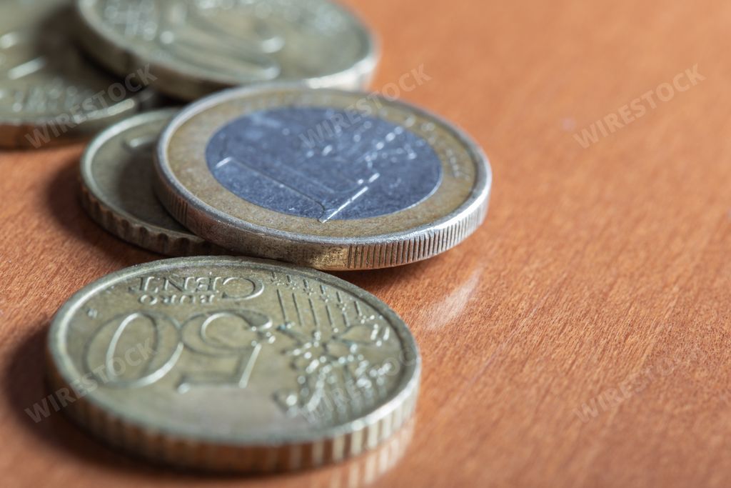 A closeup shot of some colorful euro coins on a wooden table