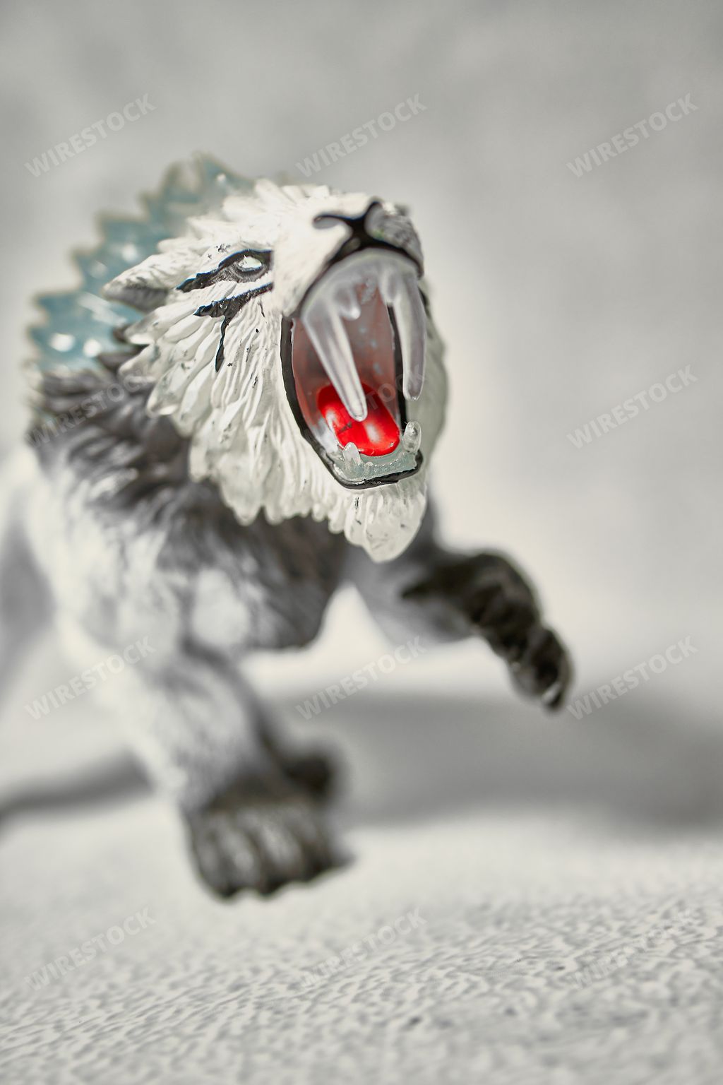 A vertical shot of a saber-toothed tiger figure from Schleich Eldrador Creatures on a white background
