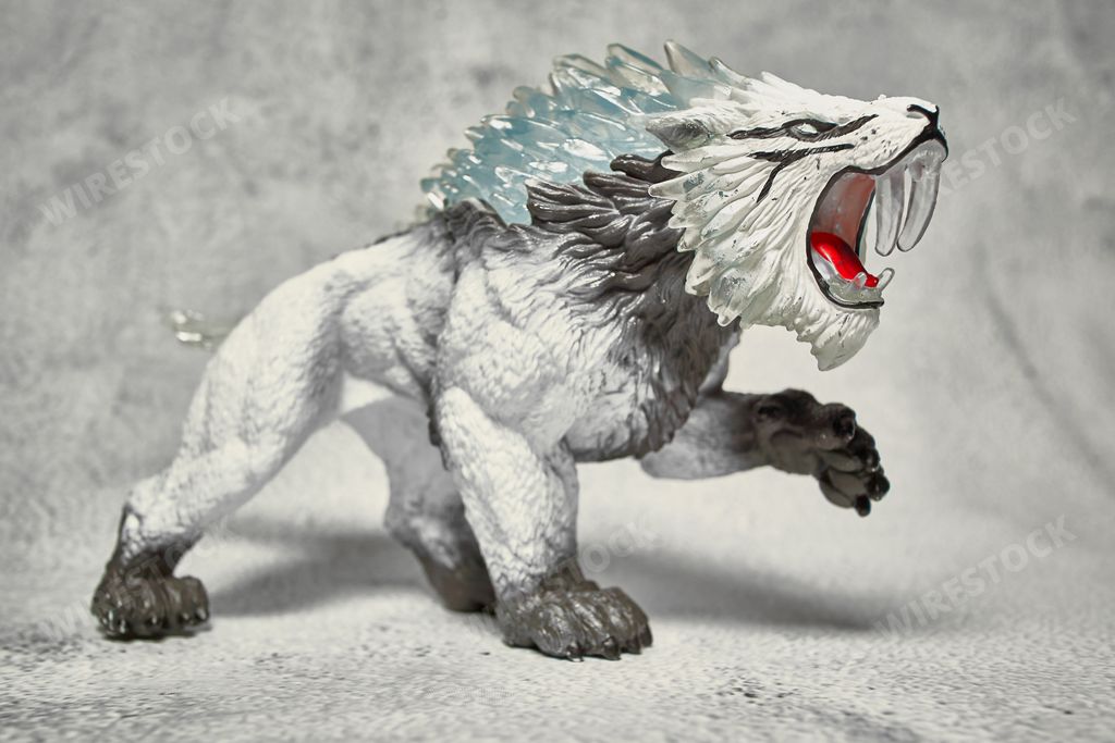 A closeup of a saber-toothed tiger figure from Schleich Eldrador Creatures on a white background