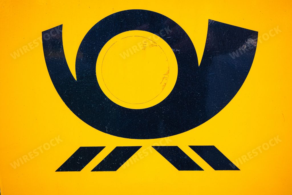 a closeup shot of a logo from the german - Deutsche Post - from a yellow mailbox