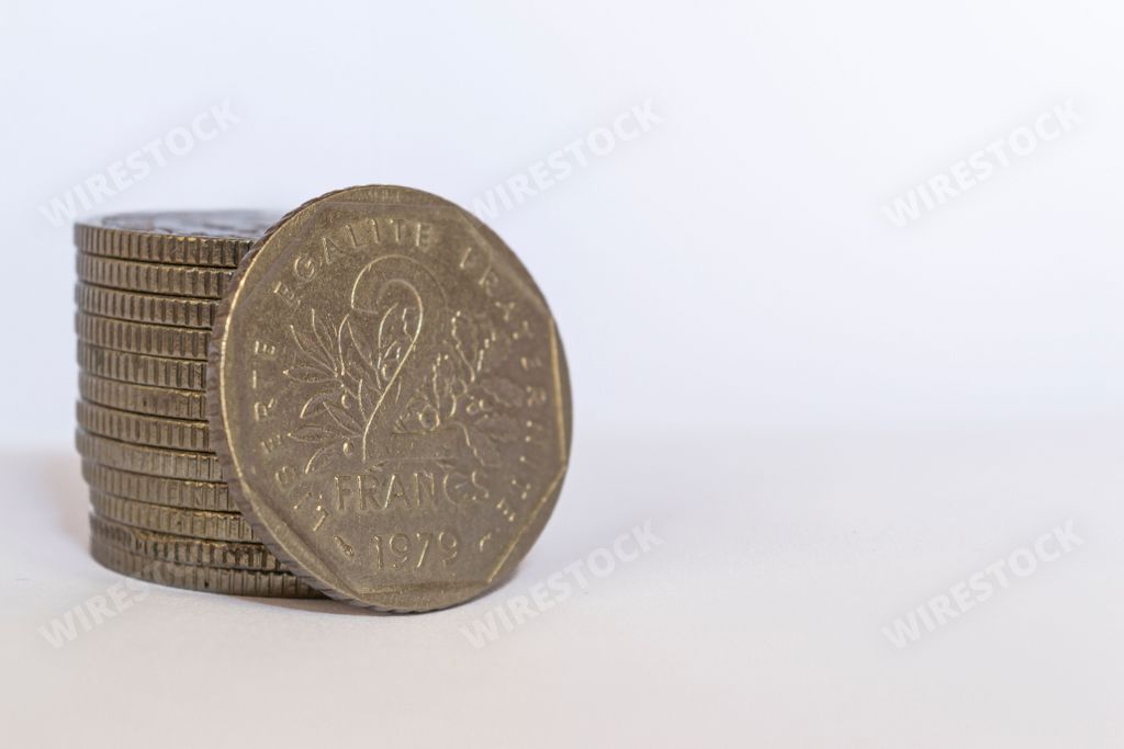 A small French franc coin isolated on a white background