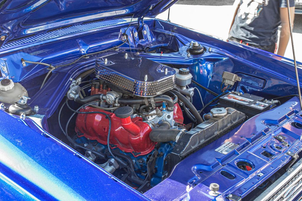The engine of a vintage Ford Taunus 20m from 1969's outdoors in daylight