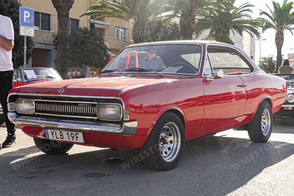 A vintage old-timer red Opel rekord coupe car.