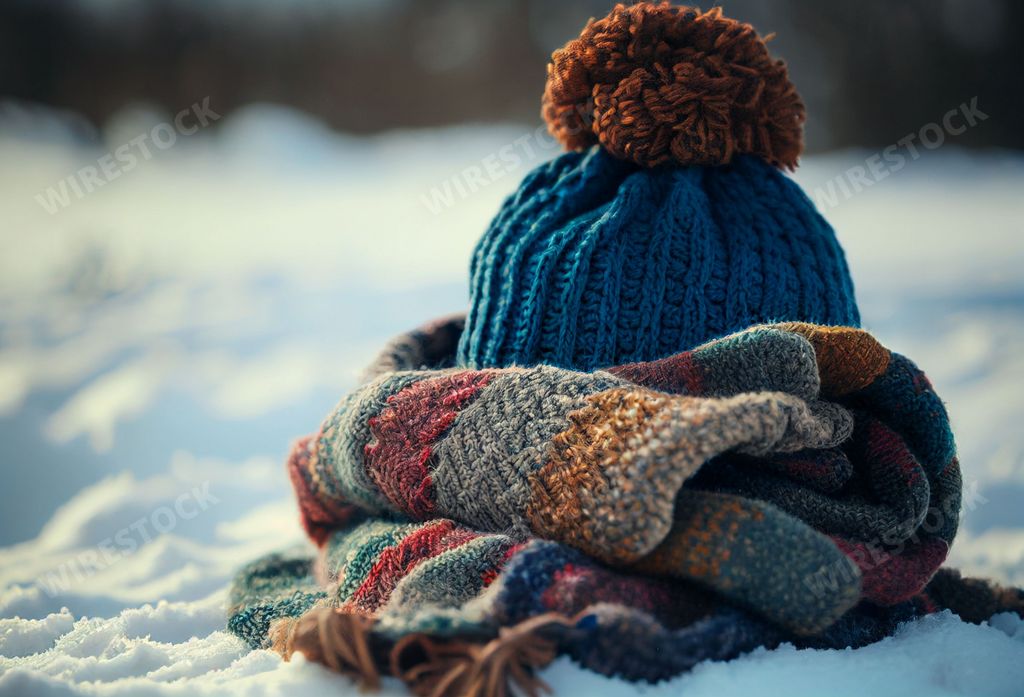 An AI generated illustration of a stylish and modern woolen hat and scarf on a background of snow-covered ground