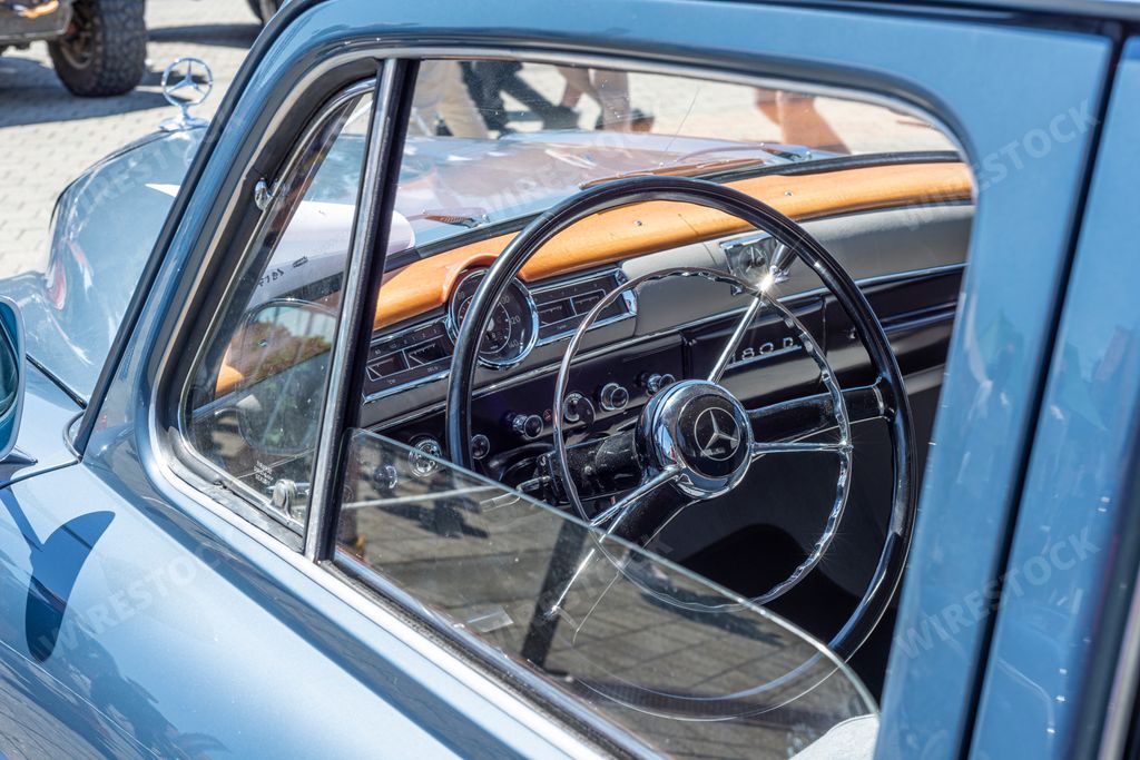 A vintage blue Mercedes car displayed at the classic car exhibition