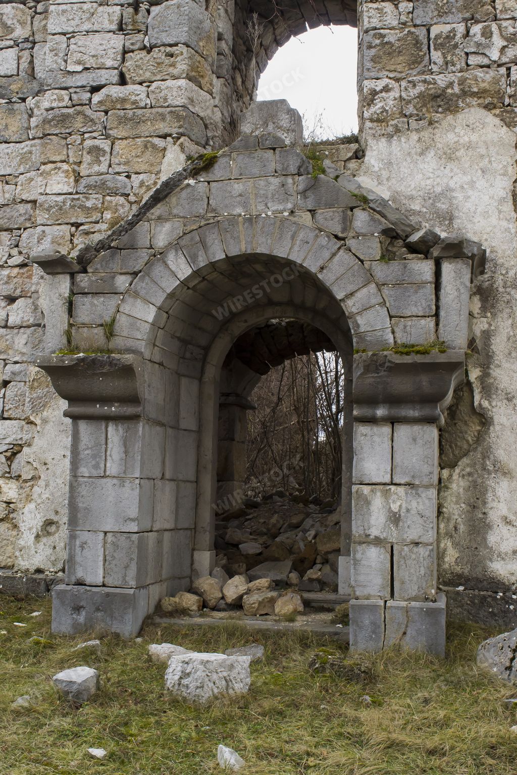 A vertical shot of the entrance of an old church ruins in Deringaj, Croatia