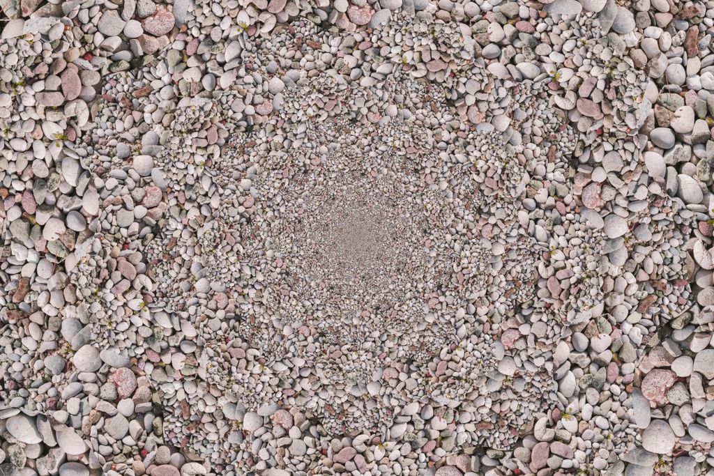 A pile of pebbles put in a round pattern, gradually zooming out in the middle
