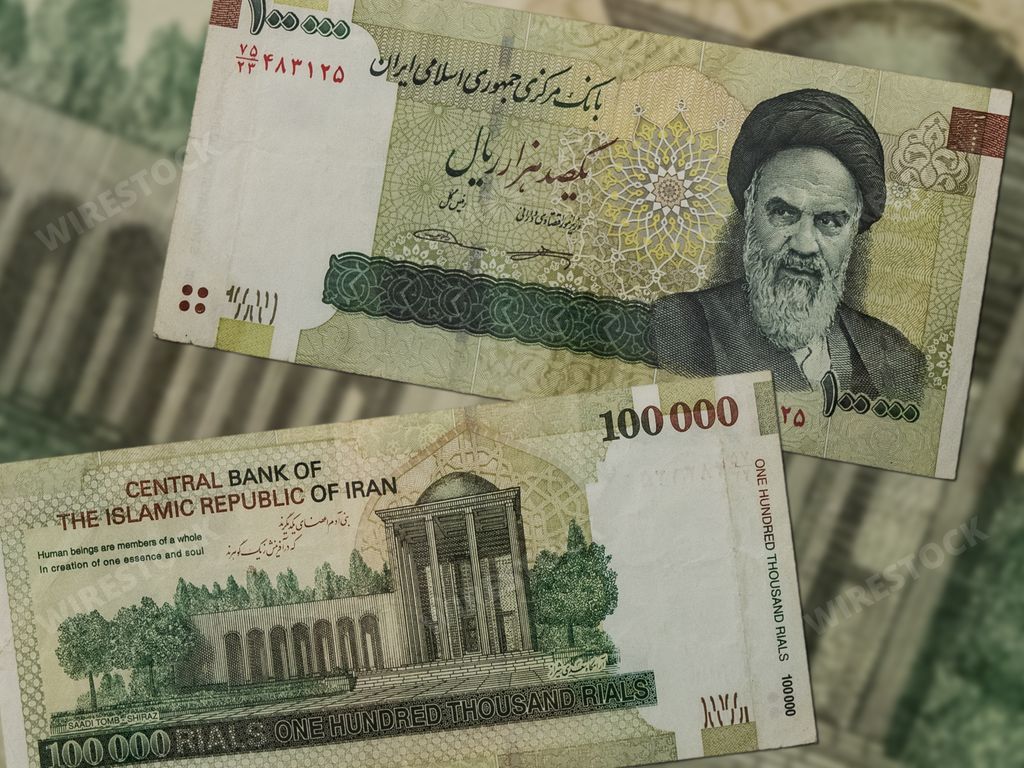 Two Iran Rial banknotes depicting Ayatollah Khomeini on the table