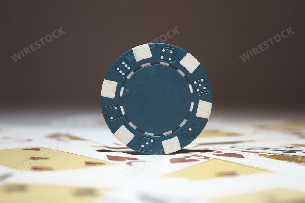 A selective focus shot of blue poker chip - casino and gambling concept