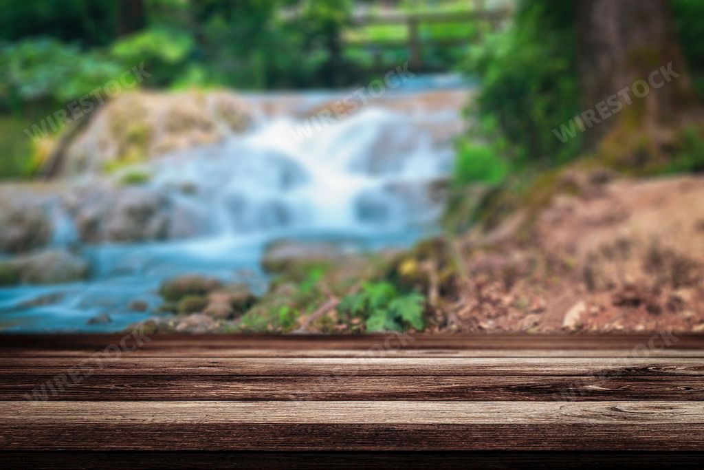 An empty wooden brown with blur nature waterfall, Background for a product or food display