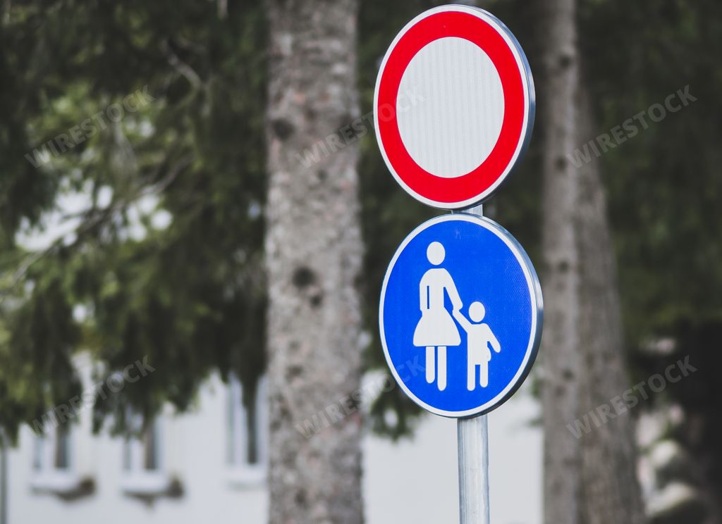 A selective focus shot of street signs such as the "Stop" sign and "Footpath for pedestrians only"