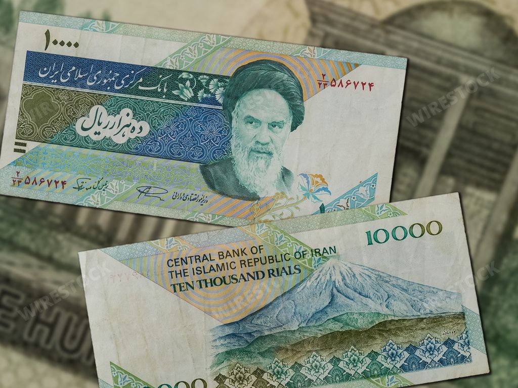Two Iran Rial banknotes depicting Ayatollah Khomeini on the table