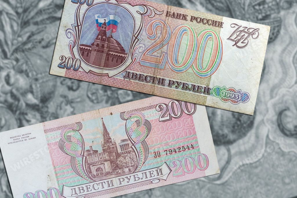 A top view of vintage soviet ruble banknotes from the USSR on a light brown surface