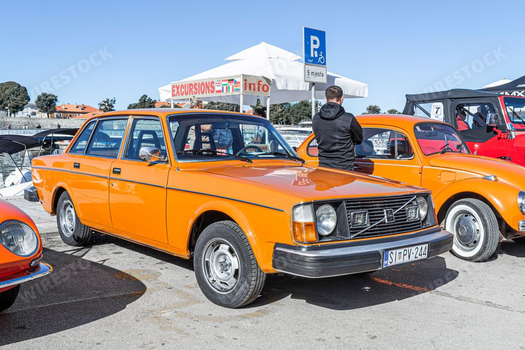 A vintage old-timer orange Swedish Volvo car.
