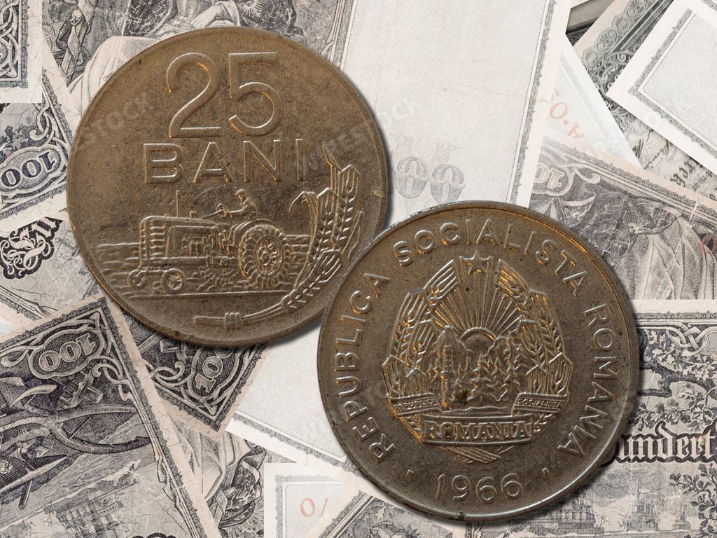 A closeup of an old Romanian Leu coin (25 bani) on banknotes background