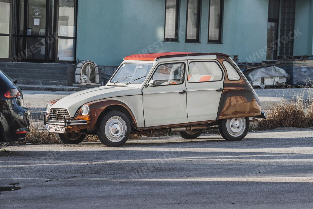 A vintage Citroen Dyane parked on the street classical oldimer car from 1970's.
